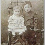 Kees en Erwin (2), 1902 Kees staand met een muziekinstrument in de hand en de andere hand op de schouder van Erwin zittend