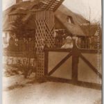 Gerard, 1915 Jongetje staand achter een hek met ingewikkeld bouwsel van hout er omheen